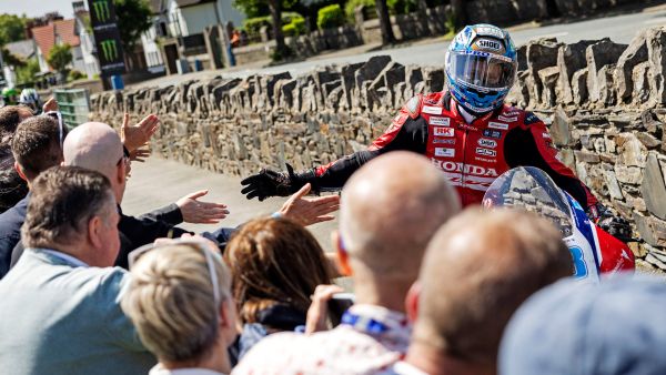 Guests high-fiving TT rider Dean Harrison as he returns from racing